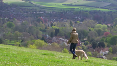 Rear-View-Of-Woman-Taking-Dog-For-Walk-Shot-On-R3D