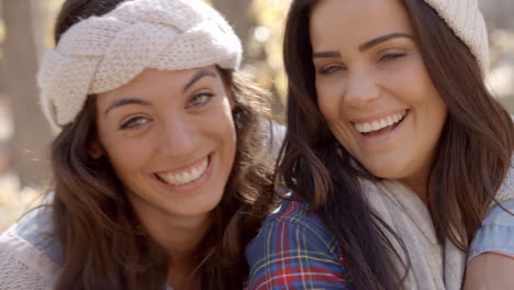 Head-and-shoulders-shot-of-happy-Lesbian-couple-in-a-forest