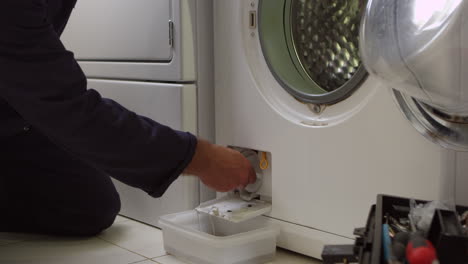 Plumber-Servicing-Domestic-Washing-Machine-Shot-On-R3D