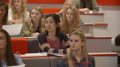 Handheld-tilt-shot-of-students-in-university-lecture-theatre