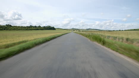Exterior-view-from-front-of-car-travelling-down-country-road