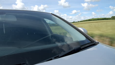 Exterior-windscreen-close-up-of-car-driving-on-country-road