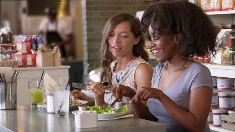 Female-Friends-Enjoying-Lunch-In-Restaurant-Shot-On-R3D