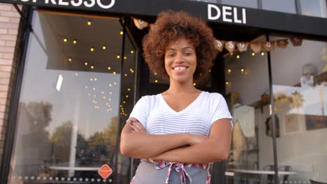 Black-female-owner-walks-into-focal-plane-outside-coffee-shop