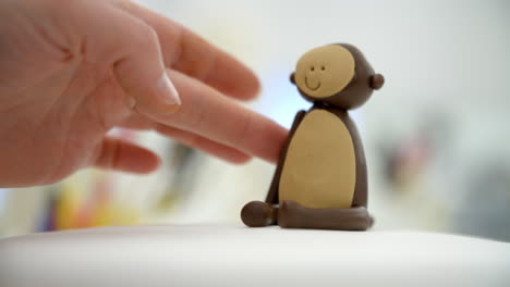 Close-Up-Of-Woman-In-Bakery-Making-Monkey-Cake-Decoration