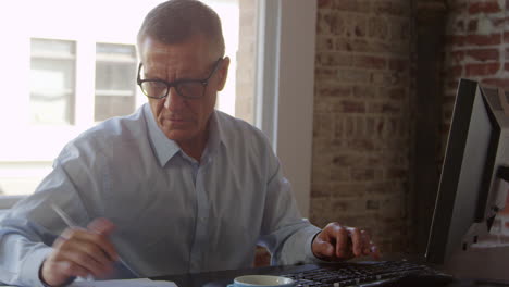 Mature-Businessman-Working-On-Computer-In-Office-Shot-On-R3D