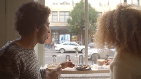 Close-Up-Of-Couple-Enjoying-Coffee-And-Cake-In-Cafe