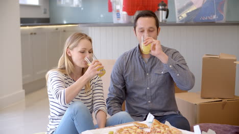 Couple-Celebrating-Moving-Into-New-Home-With-Pizza