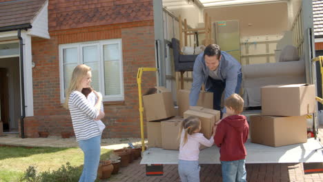 Family-Unpacking-Moving-In-Boxes-From-Removal-Truck