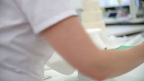 Close-Up-Of-Woman-In-Bakery-Decorating-Cake-With-Icing