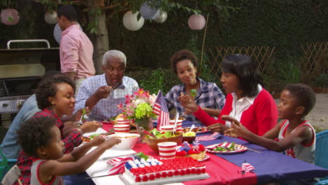 Multi-generation-black-family-at-table-for-4th-July-barbecue,-shot-on-R3D
