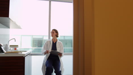 Female-Doctor-Wearing-White-Coat-In-Exam-Room-Shot-On-R3D