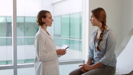Doctor-Meets-With-Teenage-Patient-In-Exam-Room-Shot-On-R3D
