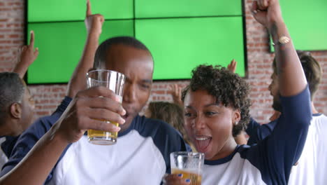Couple-Watching-Game-In-Sports-Bar-On-Screens-Shot-On-R3D