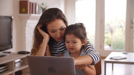 Mother-And-Daughter-Watch-Movie-On-Laptop-At-Home-Together