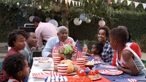 Multi-generation-black-family-talking-at-4th-July-barbecue
