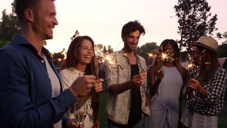 Group-Of-Friends-With-Sparklers-Enjoying-Outdoor-Party