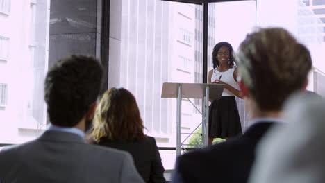 Young-black-woman-presenting-seminar-to-a-business-audience,-shot-on-R3D