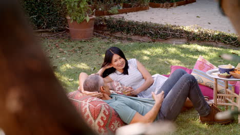 Mature-Couple-Relax-In-Garden-Together-Shot-In-Slow-Motion