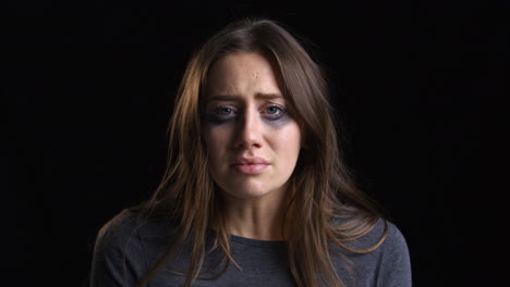 Studio-Portrait-Shot-Of-Crying-Woman-With-Smudged-Make-Up