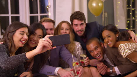 Friends-Posing-For-Photo-As-They-Celebrate-At-Party-Together