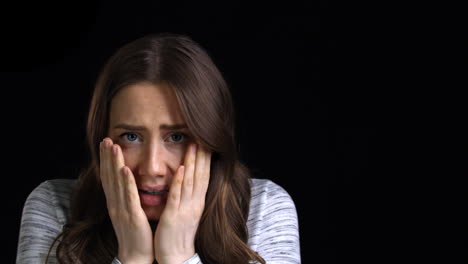 Studio-Shot-Of-Scared-Young-Woman-Flinching-From-Abuse