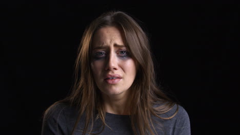 Studio-Portrait-Shot-Of-Crying-Woman-With-Smudged-Make-Up