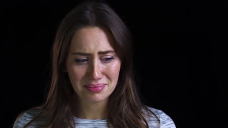 Close-Up-Of-Unhappy-Young-Woman-Crying-Into-Camera