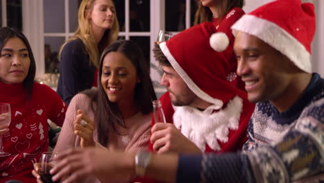 Group-Of-Friends-Having-Fun-At-Christmas-Party-Together