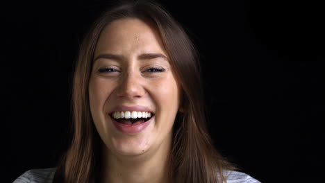 Close-Up-Of-Attractive-Young-Woman-Laughing-Into-Camera