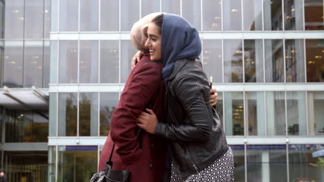 Two-British-Muslim-Women-Friends-Meeting-Outside-Office