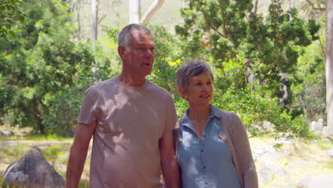 Mature-Couple-Walking-Along-Forest-Path-Together