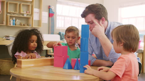 Teacher-And-Pupils-Using-Wooden-Shapes-In-Montessori-School