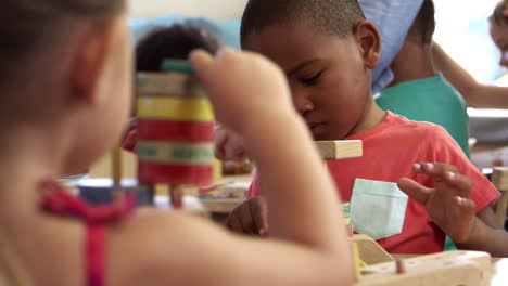 Montessori-School-Pupils-Work-At-Desk-With-Wooden-Building-Set