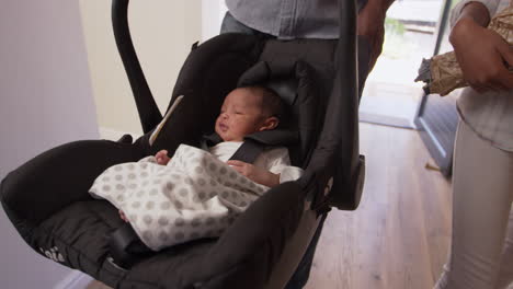 Parents-Arriving-Home-With-Newborn-Baby-In-Car-Seat