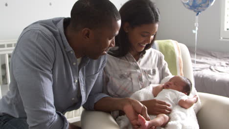 Parents-Home-from-Hospital-With-Newborn-Baby-In-Nursery