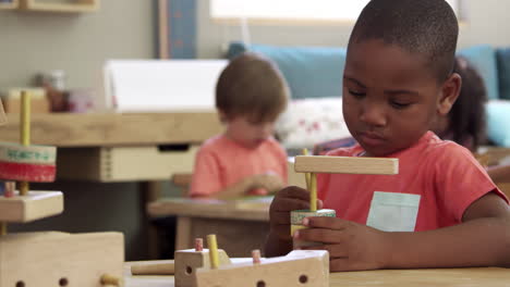 Montessori-School-Pupils-Work-At-Desk-With-Wooden-Building-Set