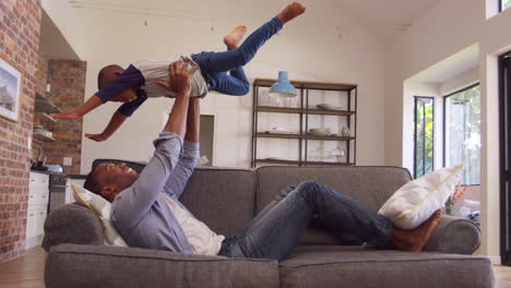 Vater-Und-Sohn-Haben-Spaß-Beim-Gemeinsamen-Spielen-Auf-Dem-Sofa