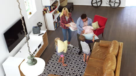 Overhead-Shot-Of-Parents-Having-Cushion-Fight-With-Children