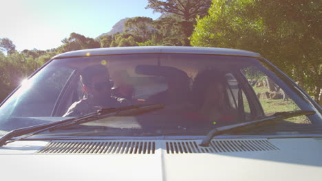 Exterior-View-Of-Friends-In-Car-Enjoying-Summer-Road-Trip