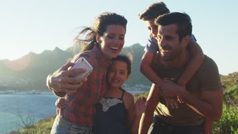 Familie-Posiert-Für-Urlaubs-Selfie-Auf-Klippen-Am-Meer
