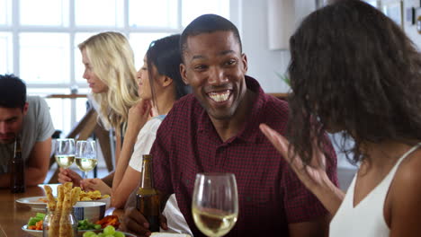 Group-Of-Friends-Enjoying-Dinner-Party-At-Home-Together
