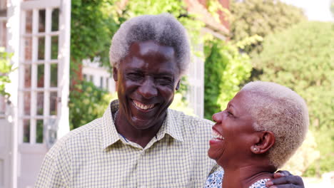 Senior-black-couple-embracing-and-smiling-in-a-garden