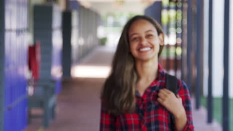 Black-teenage-girl-walks-into-focus-in-high-school-corridor