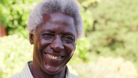 Senior-black-man-smiling-to-camera-outdoors,-close-up