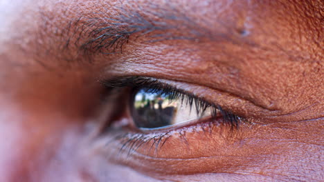 The-blinking-eye-of-a-middle-aged-black-man,-close-up-detail