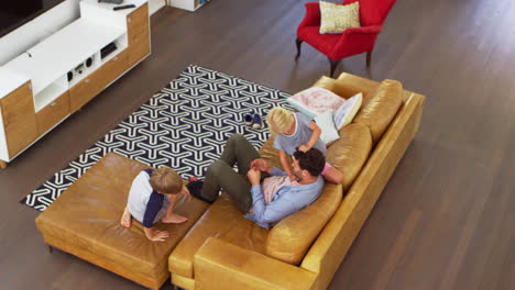 Overhead-Shot-Of-Father-Playing-With-Children-In-Lounge