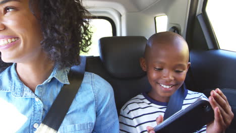 Young-black-mother-with-boy-in-a-car-going-on-road-trip