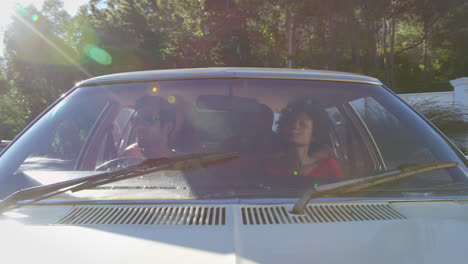 Exterior-View-Of-Friends-In-Car-Enjoying-Summer-Road-Trip