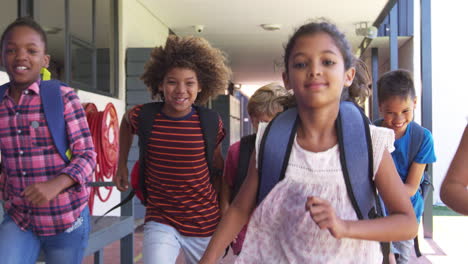 Kids-running-in-school-hallway,-front-view,-close-up